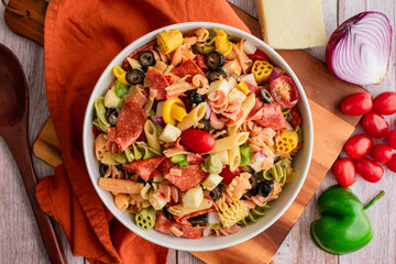 Tricolor Pasta Salad with Vegetables, Cheese, and Pepperoni: Pasta salad with grape tomatoes, bell pepper, red onion, and more