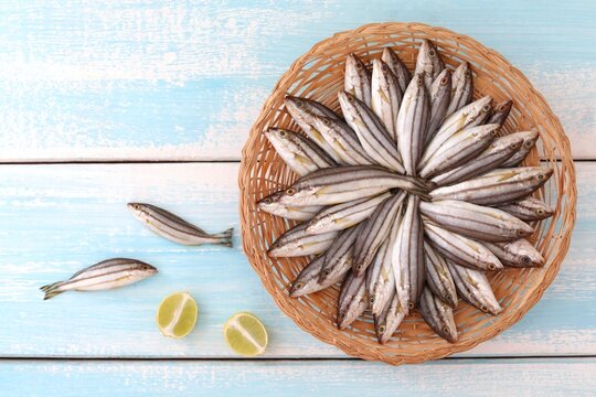Fresh Terapon jarbua fish isolated on wooden background. Marine fish, top view, background image, for presentations, place for text