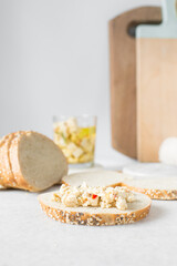 marinated feta cheese cubes on a slice of toasted bread. Cheese cubes with tomato and herbs on bread, feta cheese on slice of toast