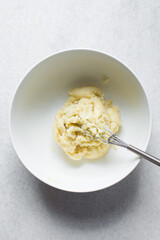 Creaming butter and sugar with a whisk, the process of making a cake, mixing butter and sugar to make a cake