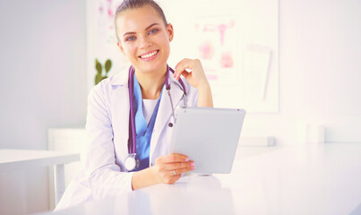 Close up Portrait of friendly female doctor with stethoscope smiling at camera.