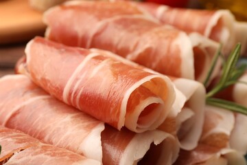 Rolled slices of delicious jamon with rosemary, closeup