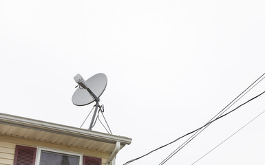 The satellite dish and radio antennas atop houses represent the transformative power of technology,...