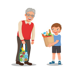 little boy helping grandfather carrying grocery bag