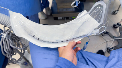 Hospital airway kit signifies emergency airway management. Endotracheal tube, supraglottic airway, laryngoscope, and Ambu bag symbolize crucial interventions for respiratory support