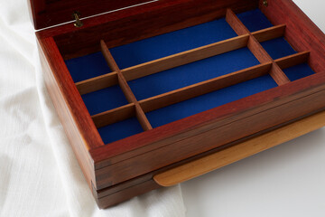 Wooden jewelry box. Product photograph on white cloth.
