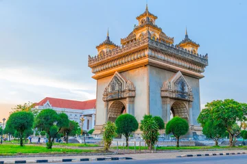 Fotobehang Patuxay a tall tower sunset with street Vientiane laos © PStyle