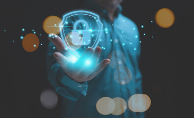 The technology of security for protect private data of personal. Technology, business, and innovation concept. Businessman holding a lock with a shield on hand to safeguard violation of privacy.