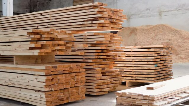 Fresh wooden slabs at the lumber storehouse. Lumber warehouse. Modular prefabricated houses concept