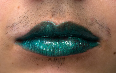 woman with a mustache wearing a green lipstick 