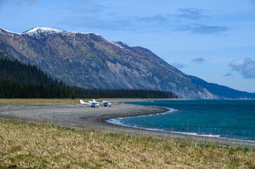 Small planes parked on the beach at Chinitna Bay in Lake Clark National Park, ecotourism in Alaska
