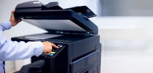 Bussiness man Hand press button on panel of printer, printer scanner laser in office copy machine supplies start concept.