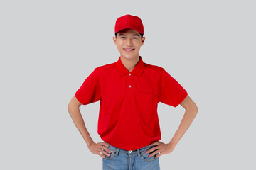 Portrait young asian man in uniform standing and smile with confident isolated white background, employee or dealer, courier and delivery, deliveryman and expression, logistic and cargo, one person.