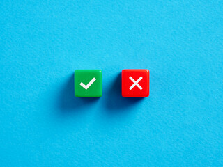 Right versus wrong. To approve or to reject. Decision making concept. Checkmark and cross symbols on colorful cubes on blue background.