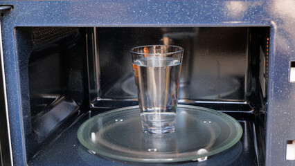Inside View of a glass of water heating in the microwave