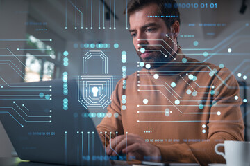 Thoughtful businessman in casual wear typing on laptop at office workplace. Concept of hard work, business education, internet surfing, information technology. Lock hologram.