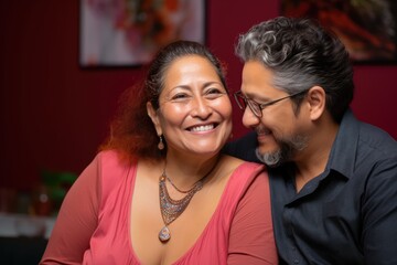 smiling senior mature hispanic couple posing together well dressed at their home