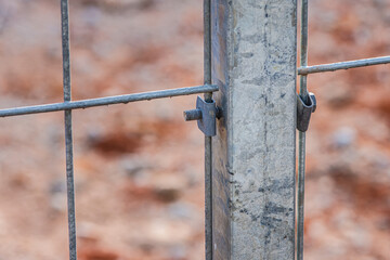 Nut and bolt connected mesh fence with column, Mesh fence of railway, selective focus.