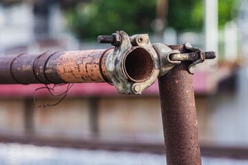 Close up of metal scaffolding rusty joint coupler, Pipe clamp scaffold lock to be strong in the construction site.