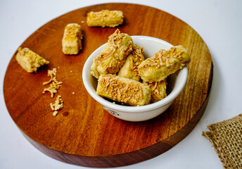 Homemade crunchy kaastengel cookies, dutch influence Indonesian cookies, served to celebrate Idul Fitri or Eid Fitri and Christmas. Selective focus image on white background. 