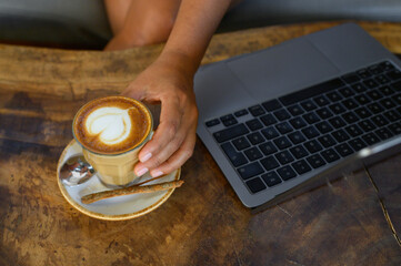 Crop woman with cup of coffee