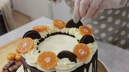 cook a cake in the kitchen. Young female pastry chef cooking a beautiful high sponge cake, pastry chef works at home, bright kitchen, video of the process