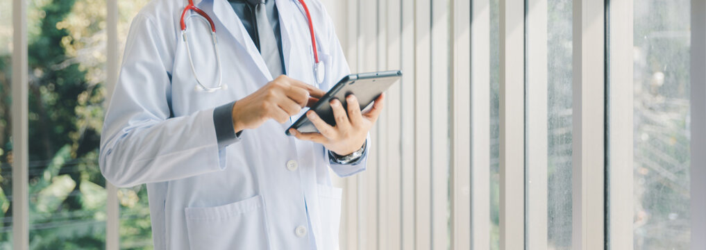 Male Asia doctor using digital tablet