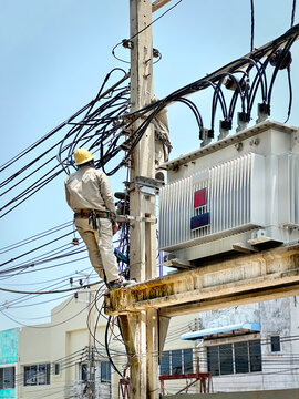 Low Angle View of an Unrecognizable Electrician Working Near the High Voltage Transformer