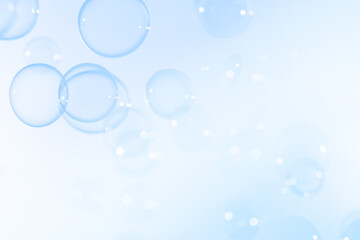 Beautiful Transparent Blue Soap Bubbles Floating in The Air. Abstract Blurred Background. Celebration Festive Backdrop. Freshness Soap Suds Bubbles Water