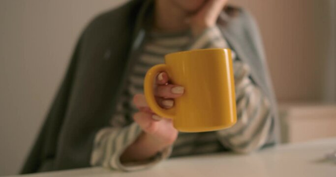 pale red-haired female patient trying to fall high temperature with water, treatment health care medicine treatment Slow motion unhealthy sad ginger girl holding yellow mug, drinking to feel better