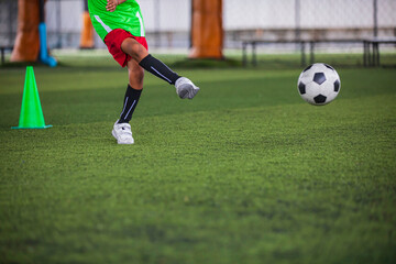 Obraz premium Soccer ball tactics children kick to control the ball on a grass field for the training