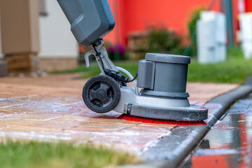 manual cleaning of concrete and stone pavements with a mechanical brush and foam