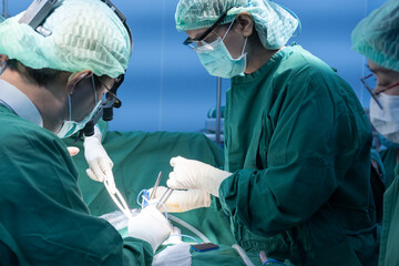 Medical team of surgeons in hospital working surgical intervention.Surgery operating room with...