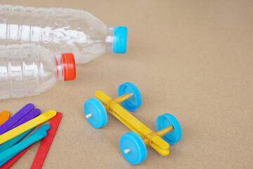 Handmade toy racing car made from ice cream sticks and bottle caps. Concept, Recycling kids toy....