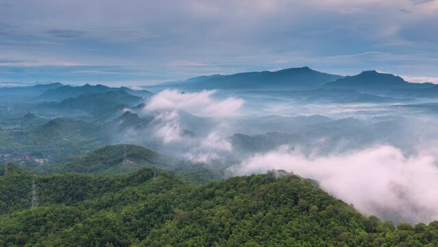 4K motion time lapse video aerial view morning scenery Mist flowing over the high mountains The movement of fog and clouds, Pang Puey, Mae Moh, Lampang, Thailand