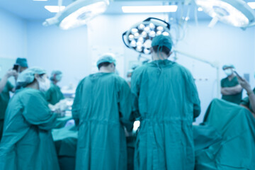 Blurry medical team of surgeons in hospital working surgical intervention.Surgery operating room...