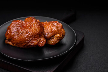 Delicious fried or smoked chicken thighs grilled with spices and herbs