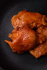 Delicious fried or smoked chicken thighs grilled with spices and herbs