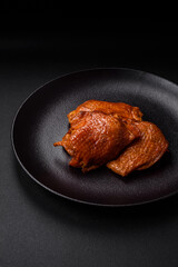 Delicious fried or smoked chicken thighs grilled with spices and herbs