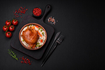 Delicious boiled rice with chicken and vegetables or risotto with salt, spices and herbs