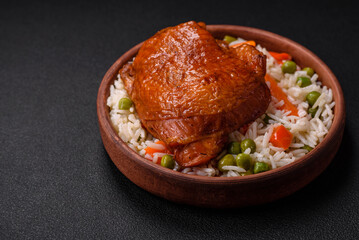 Delicious boiled rice with chicken and vegetables or risotto with salt, spices and herbs