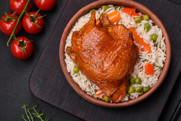 Delicious boiled rice with chicken and vegetables or risotto with salt, spices and herbs