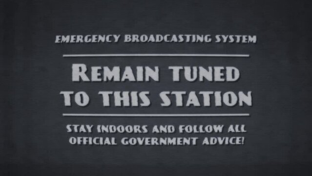 A TV caption card in a retro 1950s style with the wording &lsquo;Emergency Broadcasting System, Remain Tuned To This Station&rsquo;. The graphics are stylised in a poor-quality black and white analogue TV style, 
