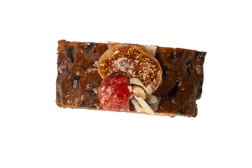 A cake with dried fruits, raisins almonds, dried strawberry.