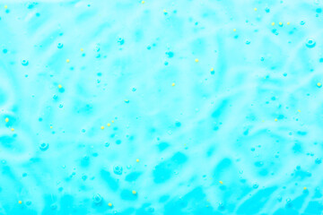 Cosmetic gel close-up with oxygen bubbles. Textured background with microbrushes in cosmetics. Moisturizing skin serum with vitamins and collagen.