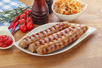 Grilled sausages with cabbage and sauce