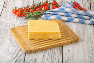 Piece of natural organic cheese over board