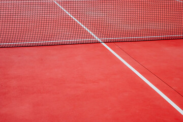 net of an empty red tennis court