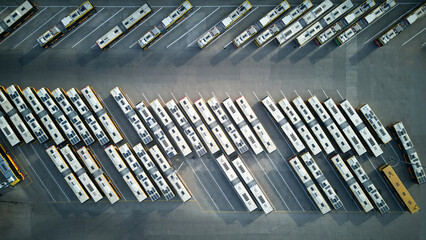 Aerial top down shot of bus terminus, designated place where bus or coach starts or ends its...