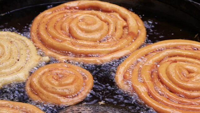 Closeup Shoot Delicious Testy sweet  jalebi fried in the cooking pan on a street food market in Chakbazar, Dhaka-Bangladesh